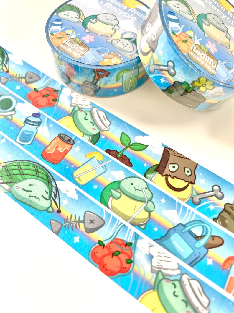 May include: Three rolls of washi tape with a blue background and a rainbow design. The tape features illustrations of turtles, a can of soda, a glass of lemonade, a plant, a bag of oranges, a fish bone, and a shovel. The text on the tape reads "Reduce Reuse Recycle" and "itsdilful washi tape".
