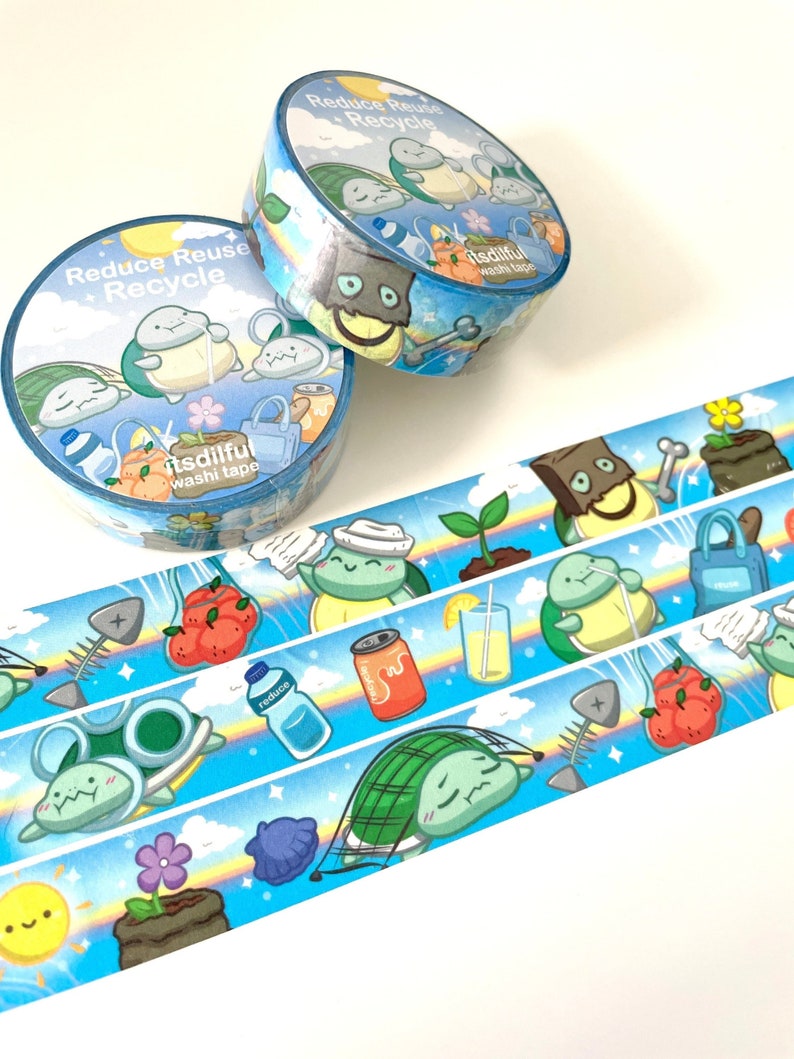 May include: Two rolls of blue and orange washi tape with a cartoon turtle design. The tape features the text "Reduce Reuse Recycle" and "itsdiful washi tape".
