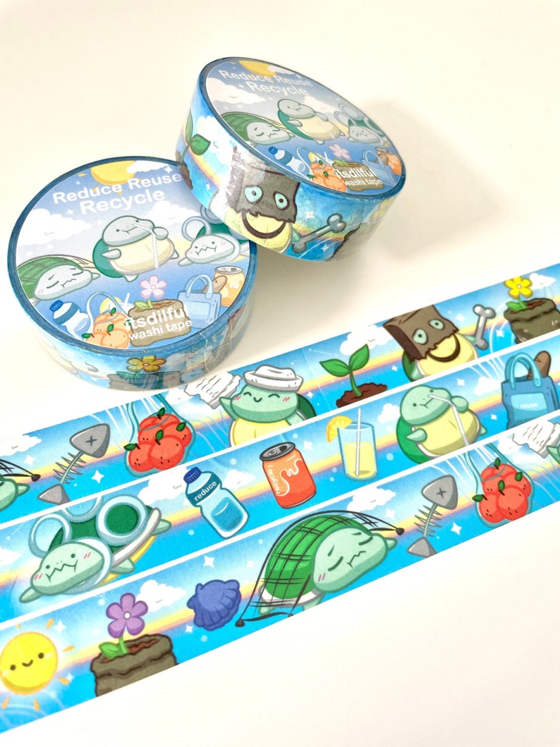 May include: Two rolls of blue and white washi tape with a repeating pattern of turtles, clouds, and various items related to recycling. The text on the tape reads "Reduce Reuse Recycle" and "Itsdiful washi tape".