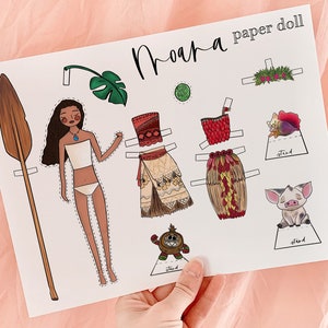 May include: A printable paper doll set featuring Moana from the Disney film Moana. The set includes Moana's body, a paddle, a flower crown, a green leaf, a red and brown skirt, a red and brown top, a brown and white skirt, a brown and white top, a pig, and a monkey.