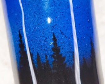 Forest silhouette against night sky with stars on 20 oz tumbler with epoxy finish