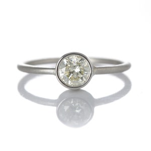 0.54ct diamond engagement ring/simple stacking ring. Pre-owned natural round cut diamond, light yellow, i2, in NEW platinum setting. image 2