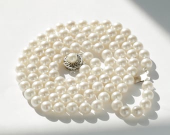 7mm Vintage cultured pearls necklace. 16"/17" double-strand high quality white cultured saltwater pearls. 14kt white gold clasp. C1960s(?).
