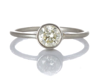 0.54ct diamond engagement ring/simple stacking ring. Pre-owned natural round cut diamond, light yellow, i2, in NEW platinum setting.