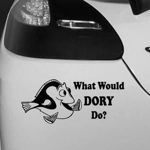 May include: Black and white car sticker showing a cartoon fish and the words "What Would DORY Do?" The sticker is on the back of a white car, close to the rear light.