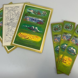 May include: A collection of vintage Christmas cards and bookmarks. The cards feature gold borders and colorful illustrations of various Christmas scenes, including snowy landscapes, tropical beaches, and fields of wheat. The bookmarks have similar imagery.