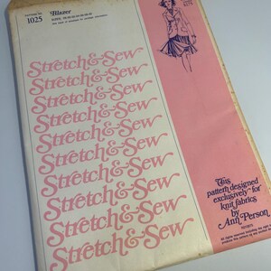May include: Vintage sewing pattern envelope with a pink background. The pattern is for a blazer and is designed for knit fabrics. The pattern number is 1025 and the text "Stretch & Sew" is repeated multiple times on the front of the envelope.