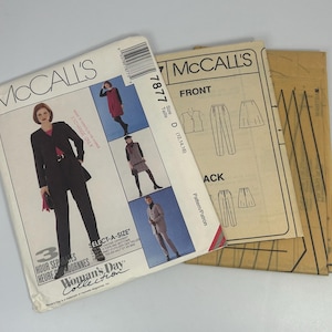 May include: McCall's sewing pattern featuring a woman's suit and other garments. The pattern packet is white with images of the finished garments and the text "Woman's Day Collection". The pattern includes sizes D (12, 14, 16).