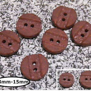 May include: Six brown ceramic buttons with two holes each. The buttons have a grooved design and measure 13mm-15mm in diameter.