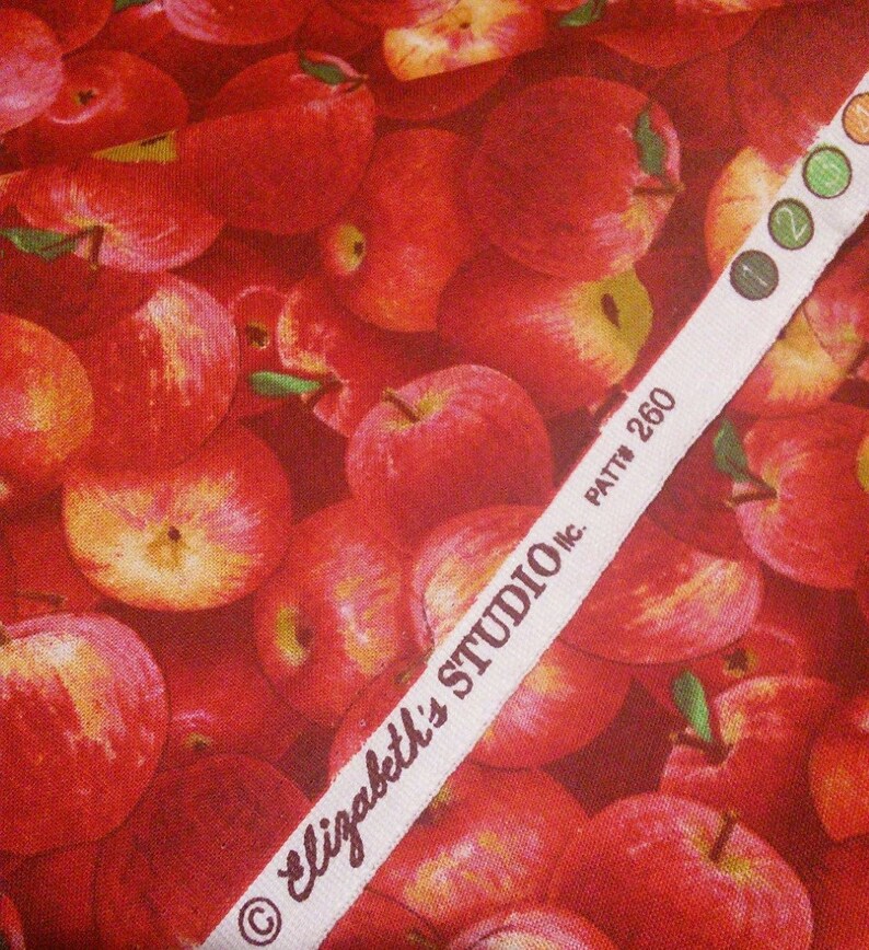 May include: Red apple fabric with a white label that reads "Elizabeth's Studio Inc. Patt # 260".