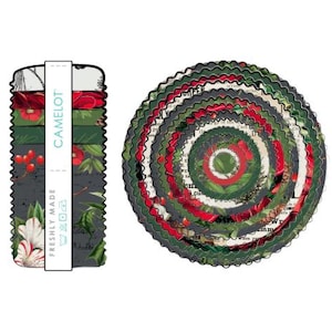 May include: A stack of circular fabric coasters with scalloped edges featuring a botanical print of red berries, green holly leaves, and white flowers on a dark background. A vertical paper band labeled CAMELOT FRESHLY MADE wraps the stack.