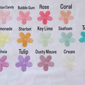 May include: A chart of 12 embroidered flower patches in various pastel colors. The colors are labeled with names like "Cotton Candy", "Bubble Gum", "Rose", "Coral", "Lemonade", "Sherbet", "Key Lime", "Seafoam", "Teal", "Fuchsia", "Tulip", "Dusty Mauve", and "Cream".