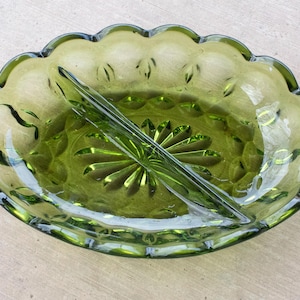 May include: A divided green glass serving dish with a scalloped edge and a raised floral design.