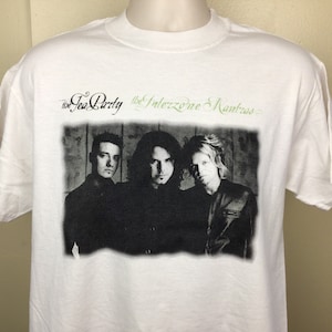 May include: White t-shirt with a black and white photo of a band, The Tea Party, with the text "The Tea Party The Interzone Mantras".