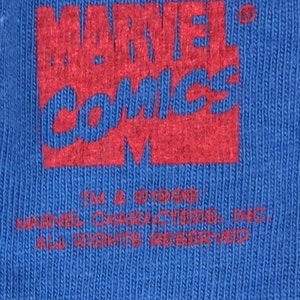 May include: Red and white "MARVEL COMICS" logo with a copyright symbol and the text "TM & &copy; 1998 MARVEL CHARACTERS, INC. ALL RIGHTS RESERVED".