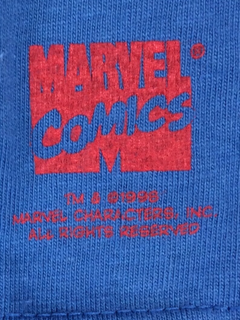 May include: Red and white "MARVEL COMICS" logo with a copyright symbol and the text "TM & &copy; 1998 MARVEL CHARACTERS, INC. ALL RIGHTS RESERVED".