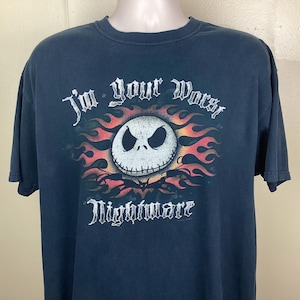 May include: Dark blue t-shirt featuring a graphic of Jack Skellington from The Nightmare Before Christmas. The design includes a skull with flames and the text "I'm your worst Nightmare".