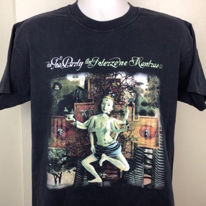 May include: Black t-shirt with a graphic print of a multi-armed figure in a seated pose. The text "The Tea Party the Interzone Mantras" is printed above the figure.