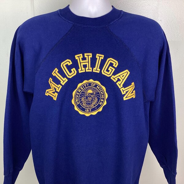 Sudadera vintage de los 80 con cuello redondo y raglán de la Universidad de Michigan de los Wolverines, fabricada en EE. UU., azul marino (talla M/L)
