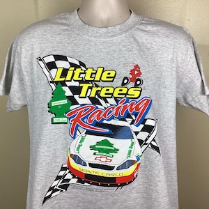 May include: Gray t-shirt with a graphic of a race car and the text "Little Trees Racing". The car is a red, white, and blue Monte Carlo with a green tree on the hood. The text is in black and white.