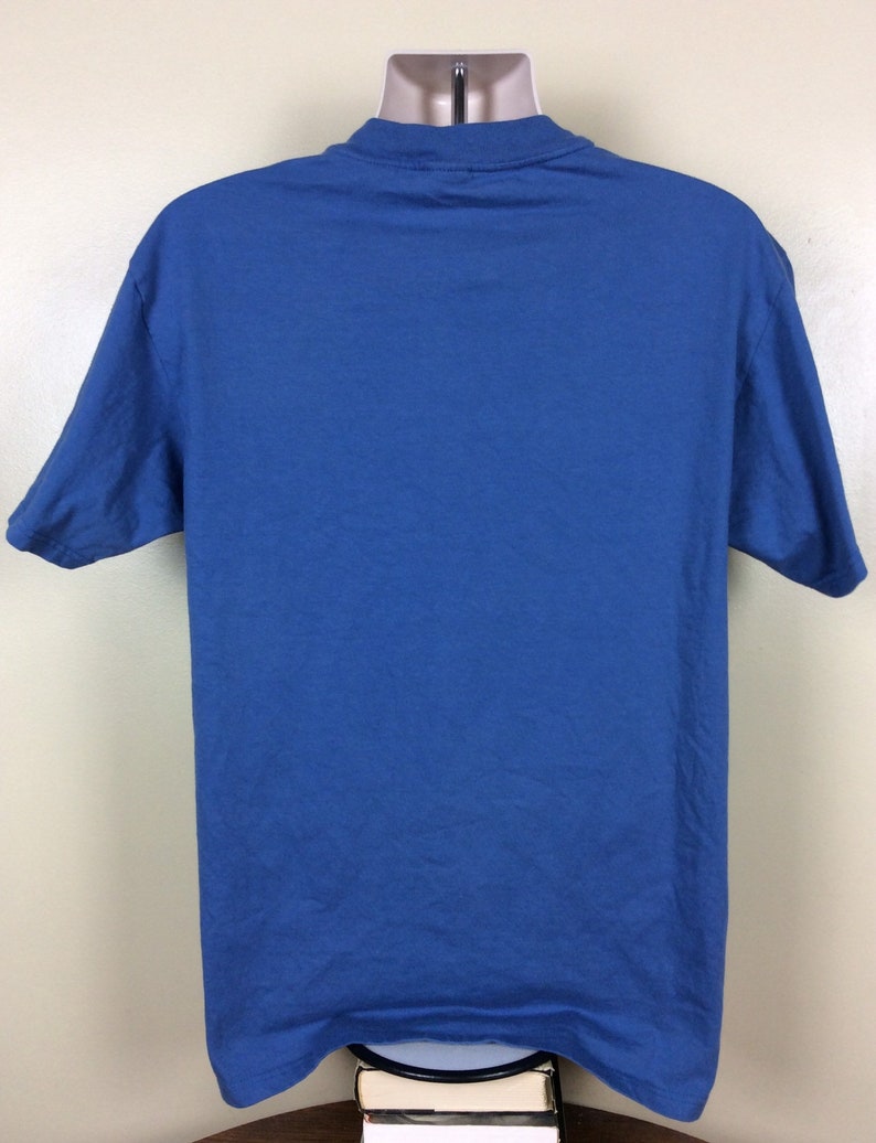 May include: A solid blue short-sleeved t-shirt.