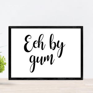May include: Black and white framed print with the text "Eh by gum" in a cursive font.