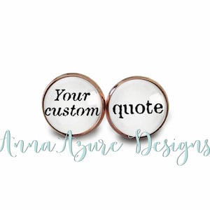 May include: Two round white glass earrings with rose gold metal settings. The left earring says "Your custom" and the right earring says "quote".