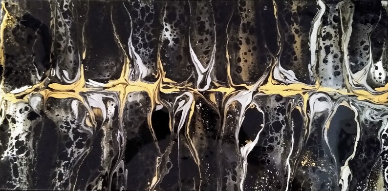 May include: Abstract art painting with black, white, and gold paint. The paint is swirled and layered to create a unique and interesting design.