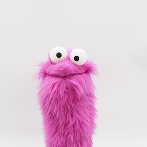 Little Gustav, a pink muppet who loves to count, would like to fly a plane and count all the airports in the world-handmade puppet with rods