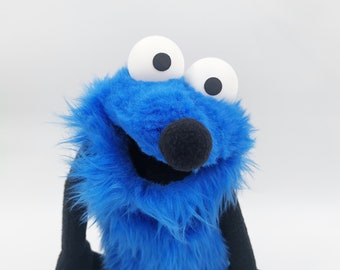 Little Gustaw, a blue muppet who likes to philosophize and ask many questions - muppet, a puppet with hands and rods.