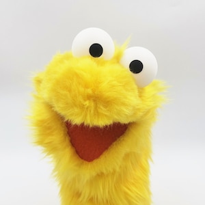 Little Gustav, a yellow muppet muppet who loves to sleep long, dance swing and read books - muppet, hand puppet