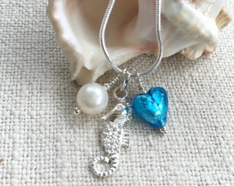 Diana Ingram three charm necklace in Sterling Silver with cornflower blue Murano glass heart white pearl and snake chain dolphin