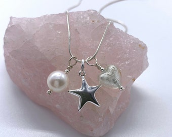 Diana Ingram three charm necklace in Sterling Silver with cornflower blue Murano glass heart white pearl and snake chain dolphin