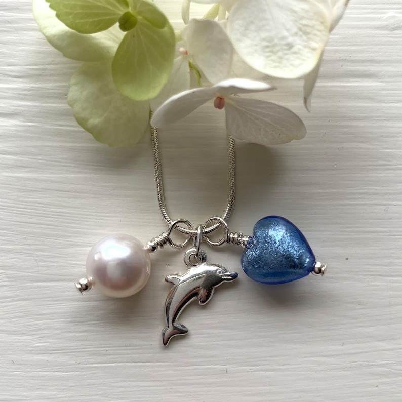 Diana Ingram three charm necklace in Sterling Silver with cornflower blue Murano glass heart white pearl and snake chain dolphin