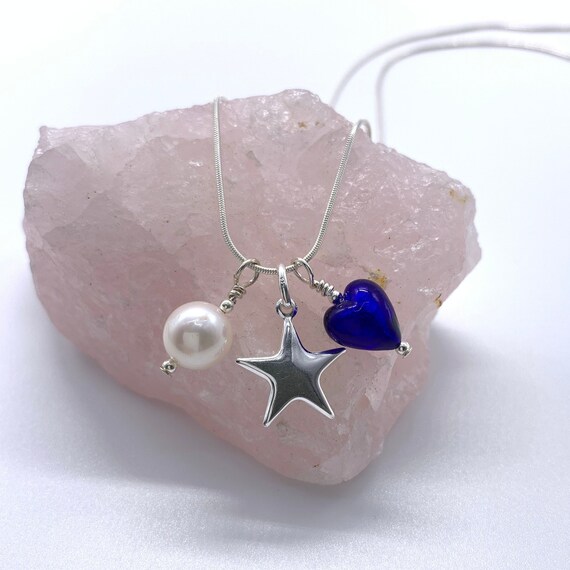 Diana Ingram three charm necklace in Sterling Silver with cornflower blue Murano glass heart white pearl and snake chain dolphin