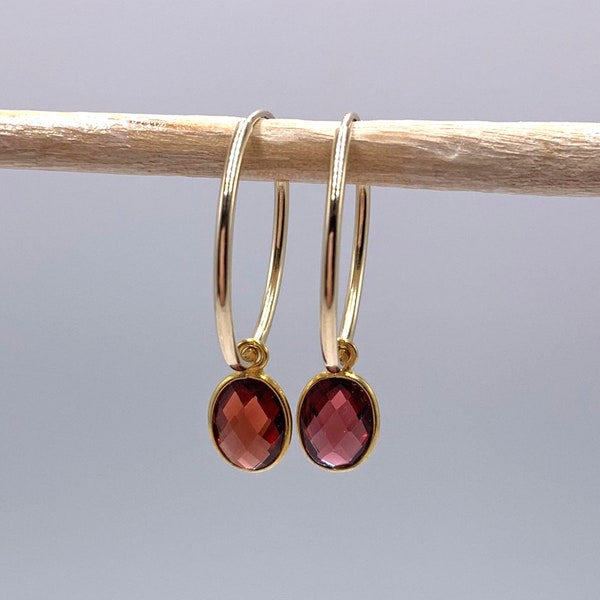 Diana Ingram earrings with garnet (dark red) oval crystal gemstones on 22 Carat gold vermeil medium hoop sleeper ear wires