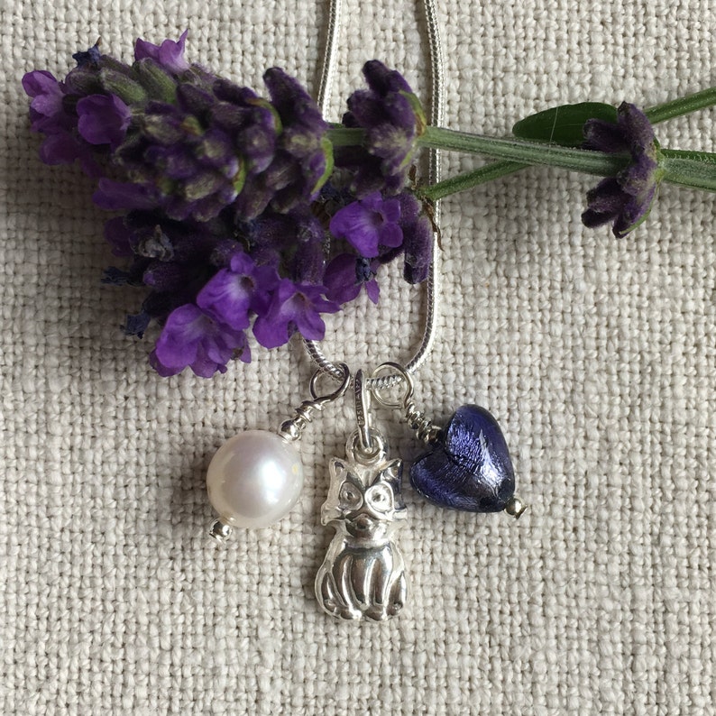 Diana Ingram three charm necklace in Sterling Silver with cornflower blue Murano glass heart white pearl and snake chain dolphin