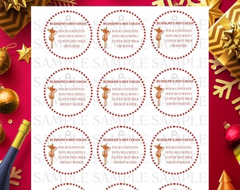May include: Nine red and white circular printable gift tags featuring a cartoon reindeer with the text "Rudolph's Hot Cocoa" and instructions to pour contents into a mug with one cup of hot milk or water.