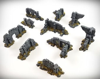 Puede incluir: Un conjunto de diez piezas de ruinas de piedra gris para juegos de mesa. Las piezas están hechas de resina y están pintadas para que parezcan piedra desgastada. Están diseñadas para ser utilizadas como terreno para juegos de guerra o juegos de rol.