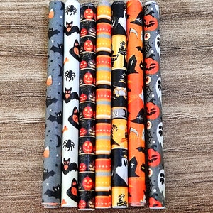 May include: Set of six Halloween-themed paper straws with various designs, including bats, pumpkins, ghosts, and witches' hats. The straws are orange, black, and white.