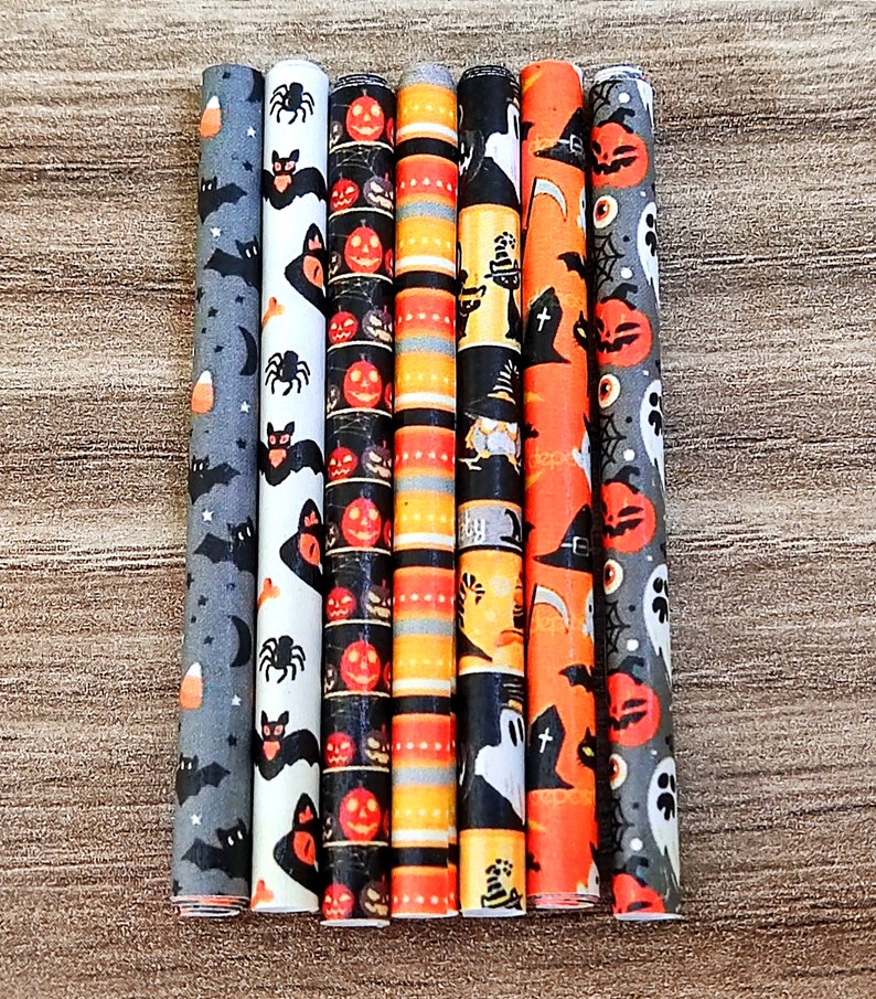 May include: Set of six Halloween-themed paper straws with various designs, including bats, pumpkins, ghosts, and witches' hats. The straws are orange, black, and white.