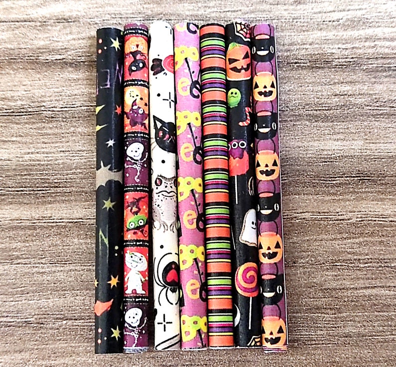 May include: Seven colorful Halloween themed paper straws with various spooky designs, including ghosts, pumpkins, bats, spiders, and candy corn.