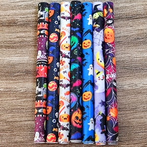 May include: Set of eight Halloween-themed straws with various designs, including bats, pumpkins, ghosts, and candy corn. The straws are black, blue, purple, and white.