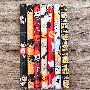 May include: Set of eight Halloween-themed straws with various designs, including black cats, spiders, pumpkins, and skeletons. The straws are wrapped in colorful paper with a variety of patterns.