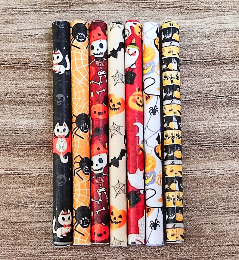 May include: Set of eight Halloween-themed straws with various designs, including black cats, spiders, pumpkins, and skeletons. The straws are wrapped in colorful paper with a variety of patterns.