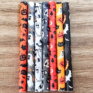 May include: Set of seven Halloween-themed straws with various patterns including ghosts, bats, spiders, pumpkins, and skulls. The straws are black and white with orange accents.