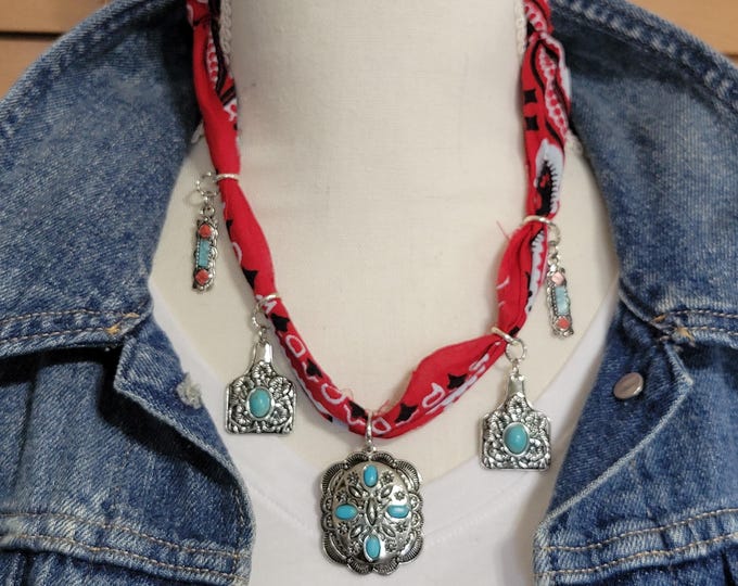 A bandana necklace with red bandana and western conchos, adorned with turquoise