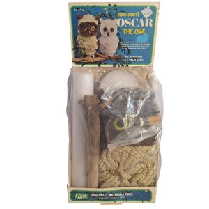 May include: A craft kit for making a 14-inch owl, featuring a box with the text "OSCAR THE OWL." The kit includes various materials like rope, wood, and foam, with images of finished owls on the box.