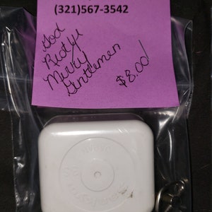 May include: A white music box with a silver winding key. The music box is packaged in a clear plastic bag with a pink price tag that reads "God Rest Ye Merry Gentlemen $8.00". B 'n' S Ceramics 930 Cheney Hwy Titusville, FL 32780 (321)567-3542