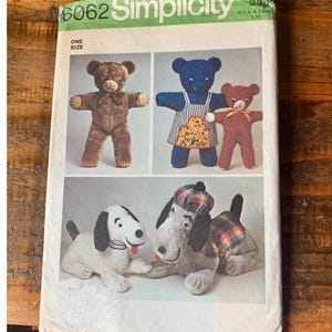 Può includere: Modello di cucito Simplicity numero 6062 per realizzare giocattoli di peluche. Il modello include istruzioni per realizzare un orsacchiotto marrone, un orsacchiotto blu con un grembiule, un orsacchiotto marrone e un cane bianco e nero con un cappello e una sciarpa a quadri.